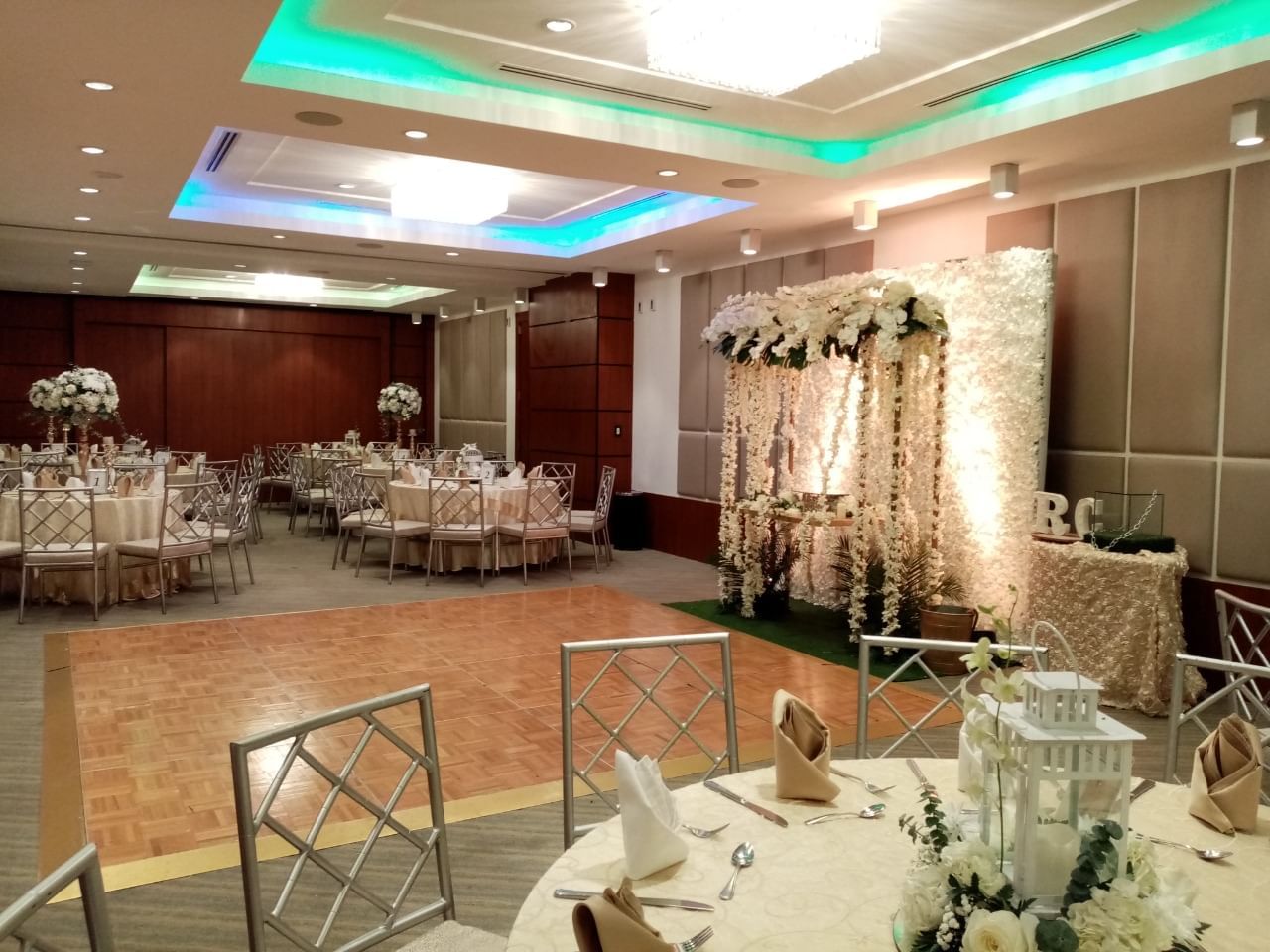 Salón de eventos de The Executive Hotel montado para una recepción, con pista y mesas redondas