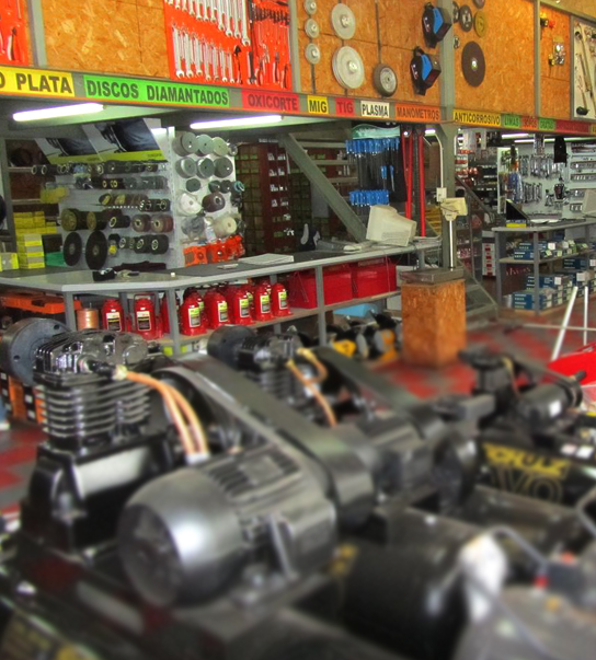 Pasillo interior de Ferretería EMCOB con discos de corte, abrasivos y compresores en exhibición