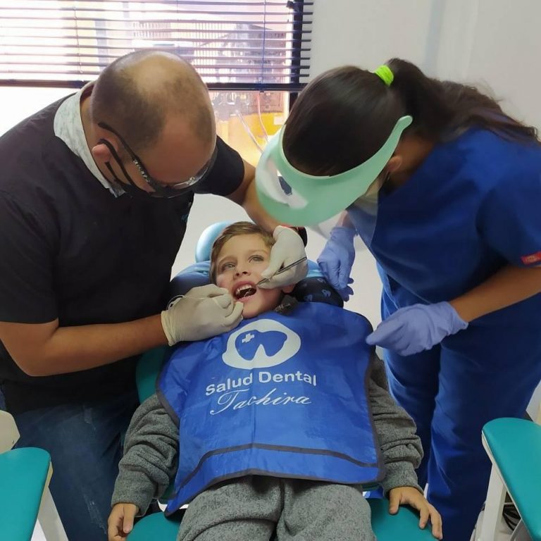 Equipo de Salud Dental Táchira revisando a un paciente niño en el sillón dental
