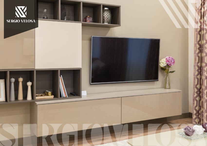 Sala con mueble de TV en madera y concreto, sillón individual y comedor al fondo